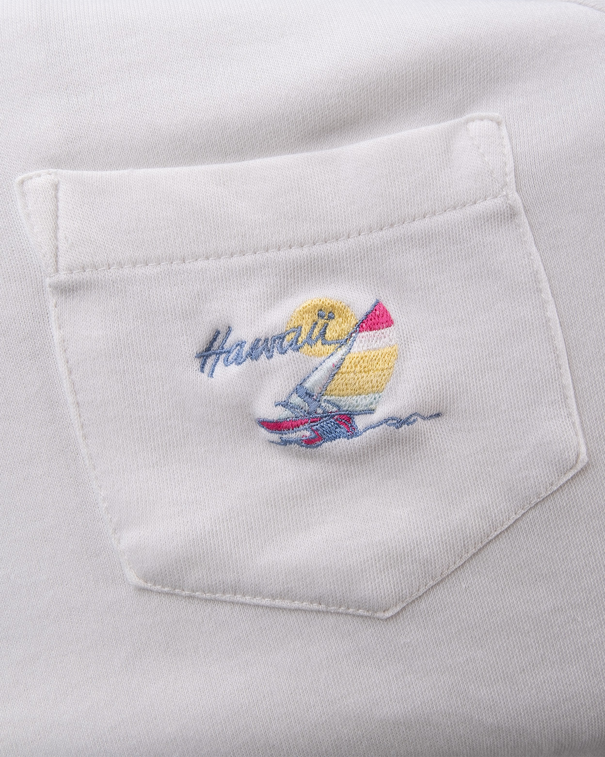 Detail of embroidered Hawaii sailboat graphic on chest pocket of vintage 5 Stars polo