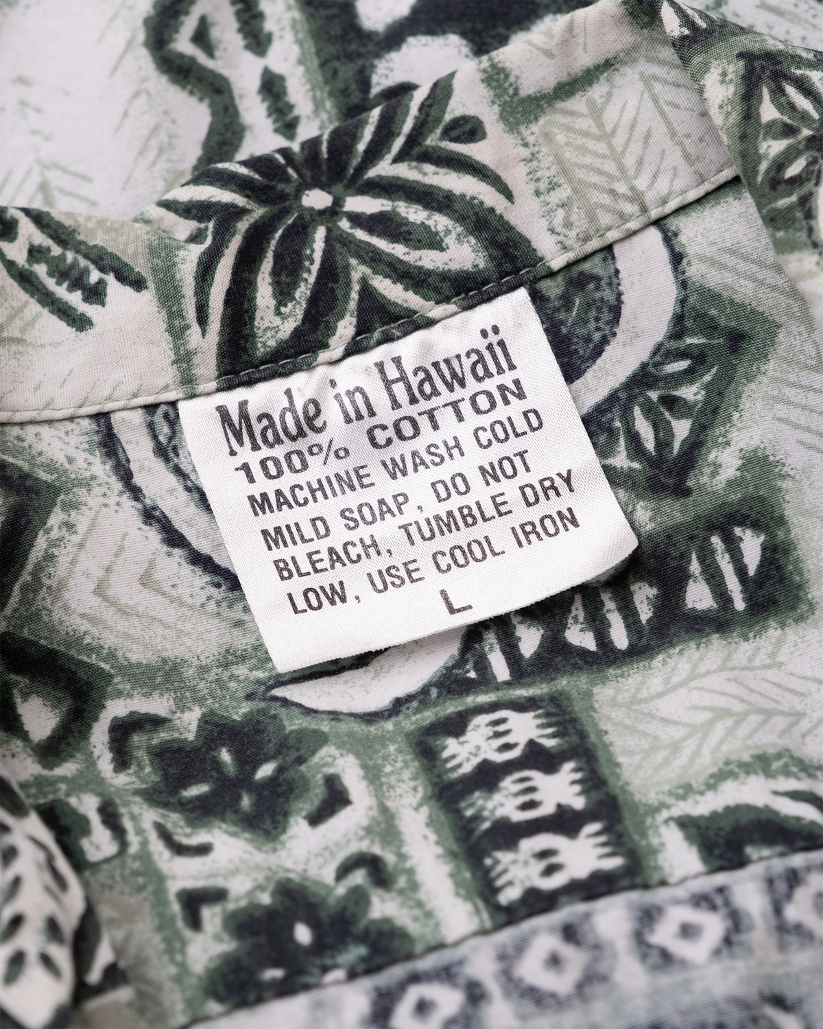 Made in Hawaii 100% cotton size Large label on vintage sea turtle aloha shirt.