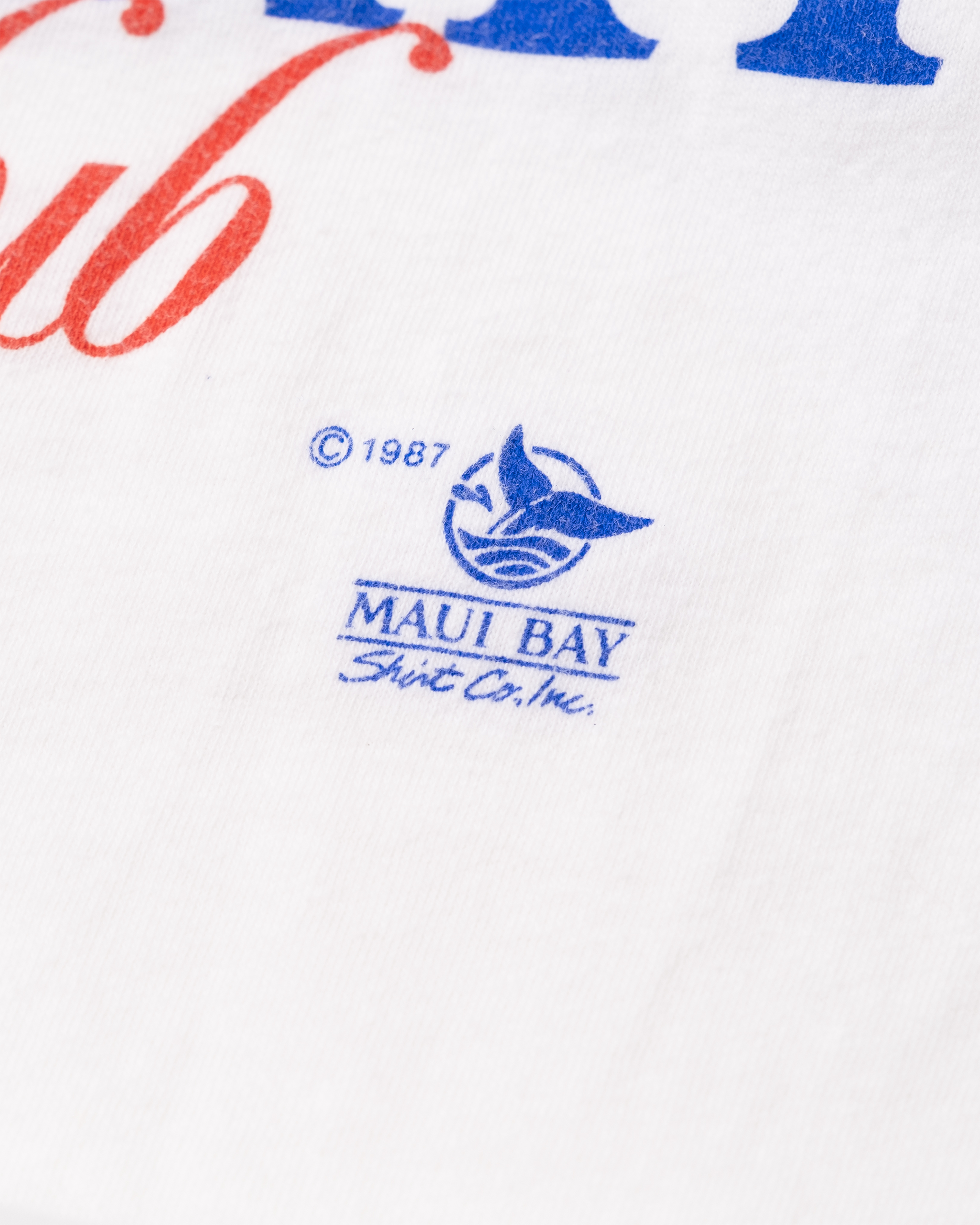 Close-up of ©1987 Maui Bay Shirt Co., Inc. logo printed on vintage Maui Bay Yacht Club tee.
