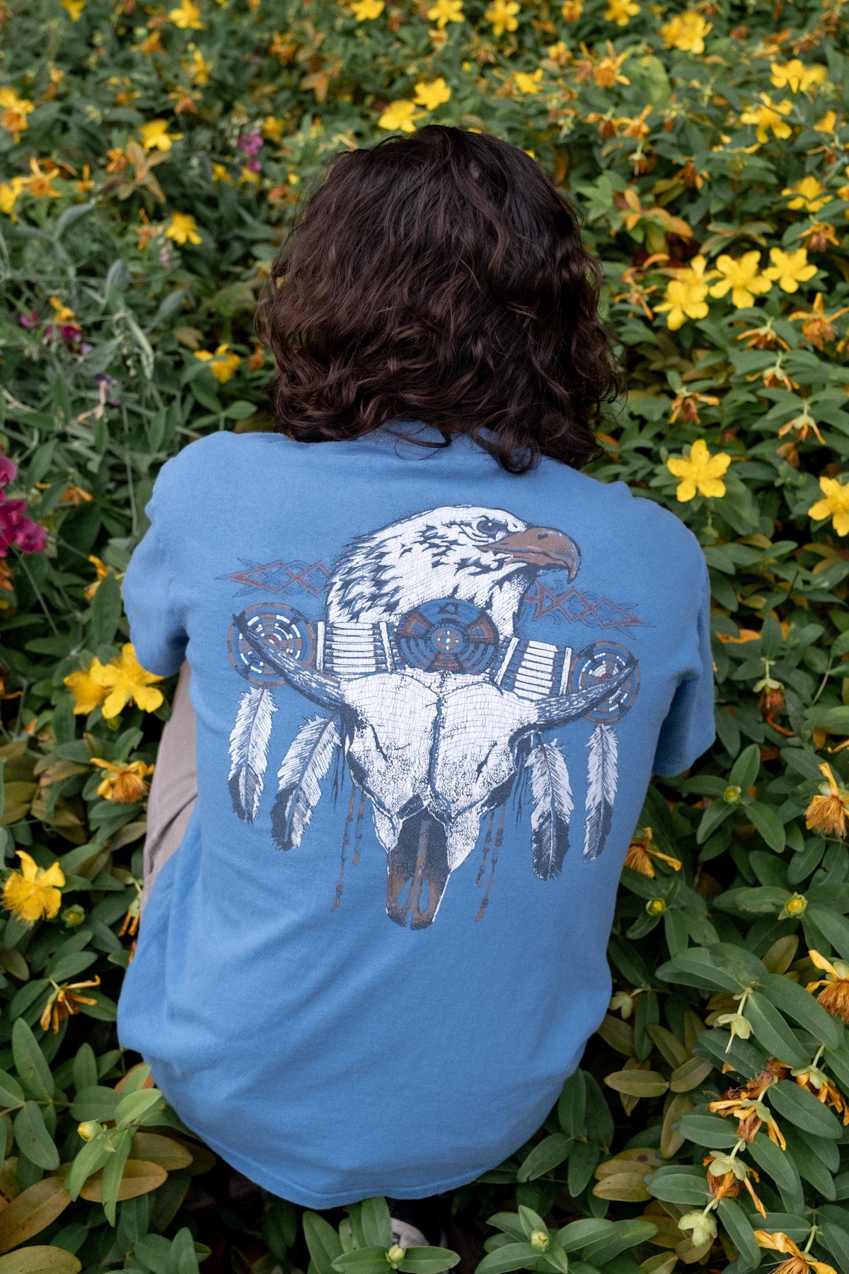 Model wearing 1990s Diamond Dust Wild West graphic tee in faded slate blue.