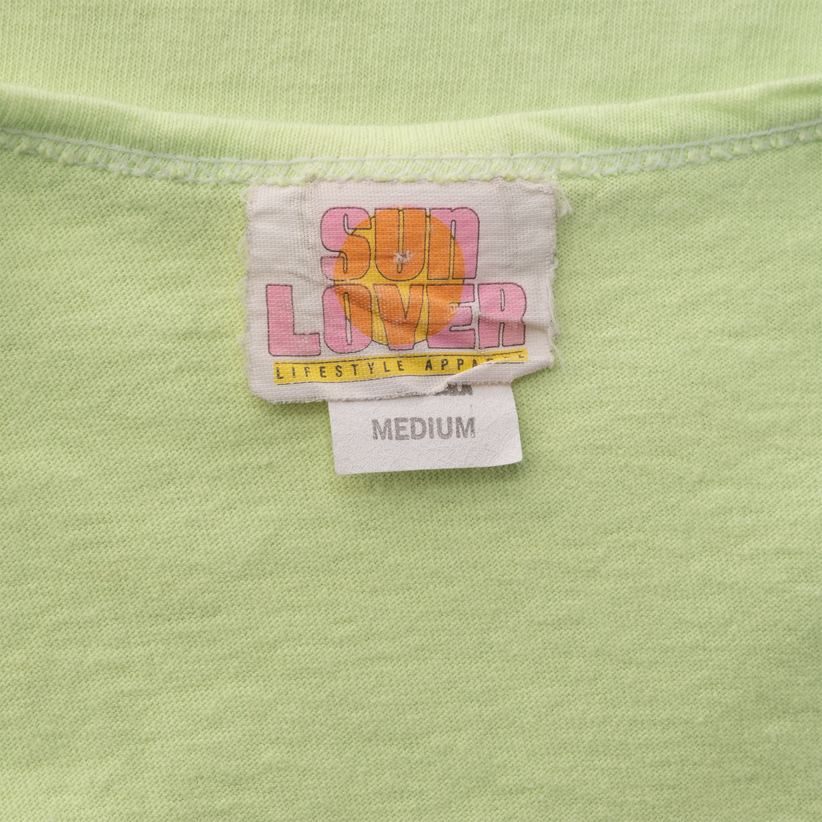 Sun Lover Lifestyle Apparel Medium neck label on vintage neon green crop tank.