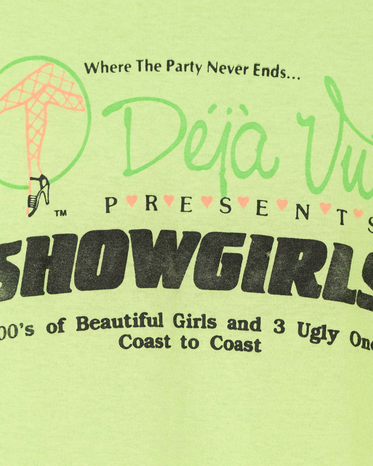 Close-up of Deja Vu Presents Showgirls back graphic on vintage neon green T-shirt.