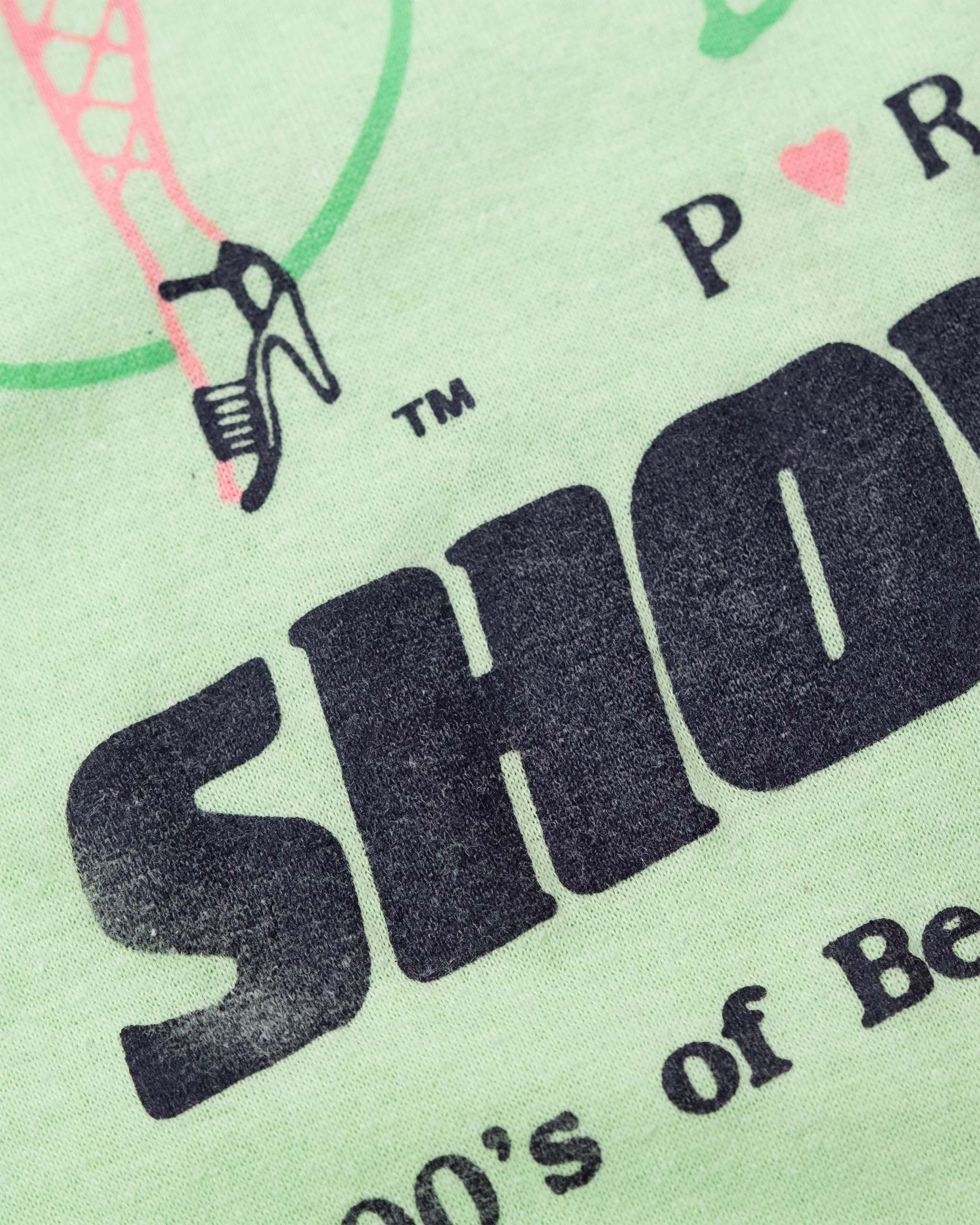 Detail of faded black Showgirls lettering on late-1980s Deja Vu graphic tee.