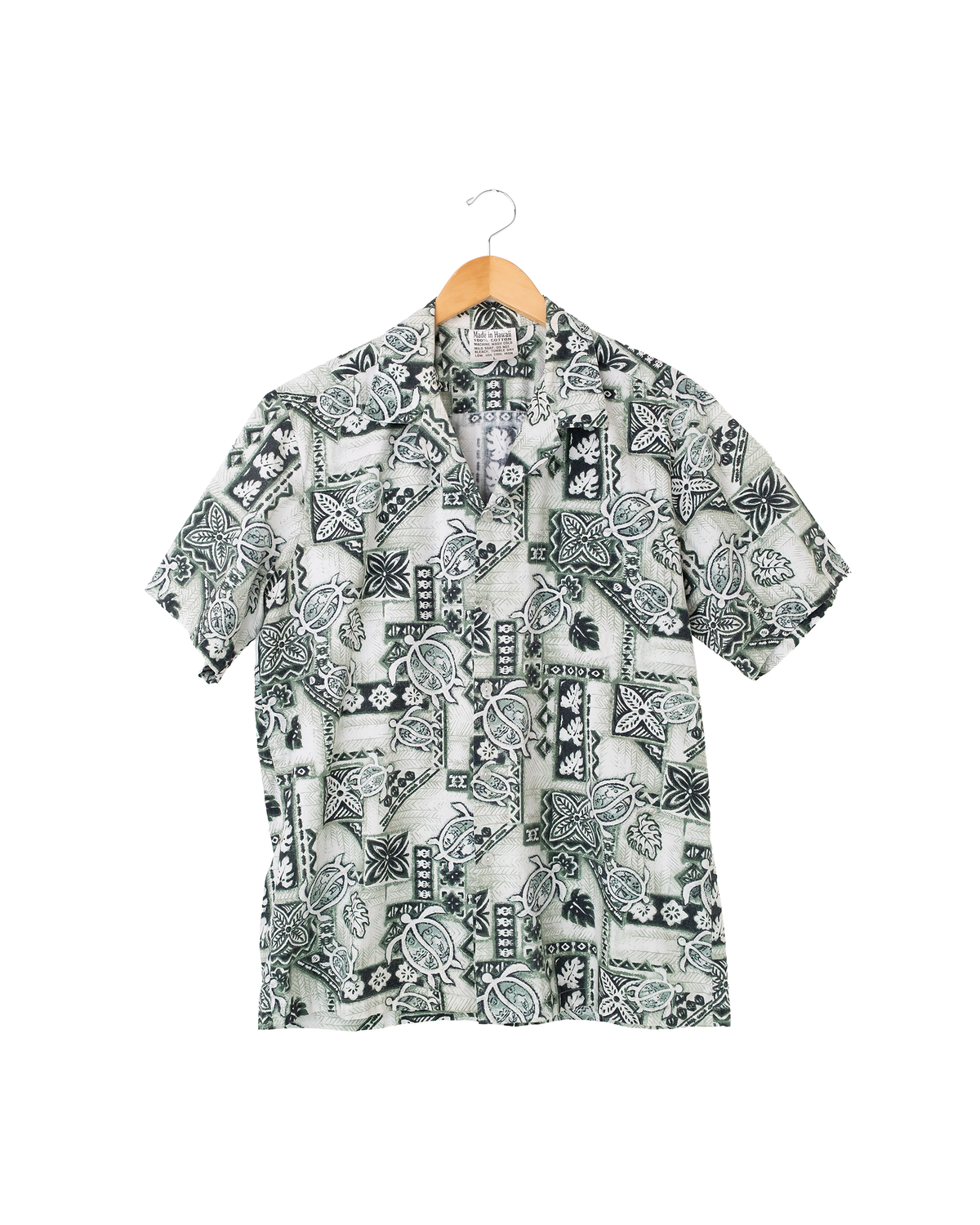 Front view of 1990s Made in Hawaii sea turtle aloha shirt in green and white tropical print.