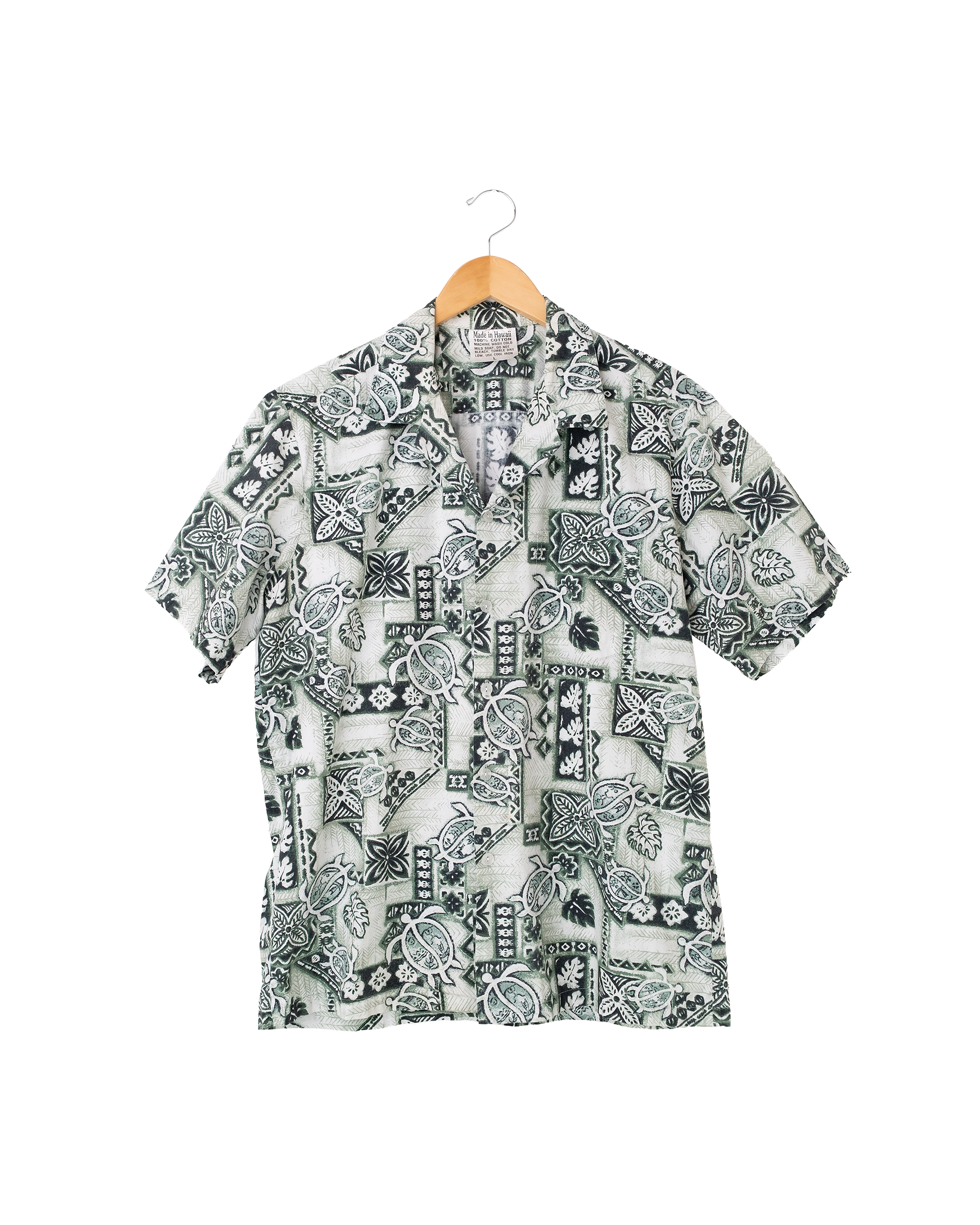Front view of 1990s Made in Hawaii sea turtle aloha shirt in green and white tropical print.