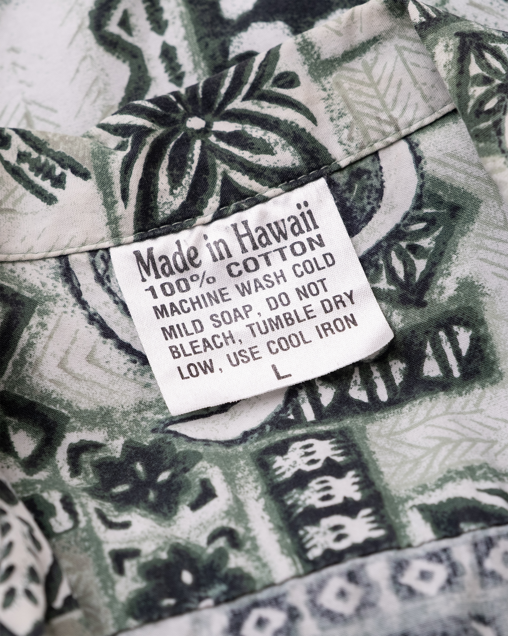 Made in Hawaii 100% cotton size Large label on vintage sea turtle aloha shirt.