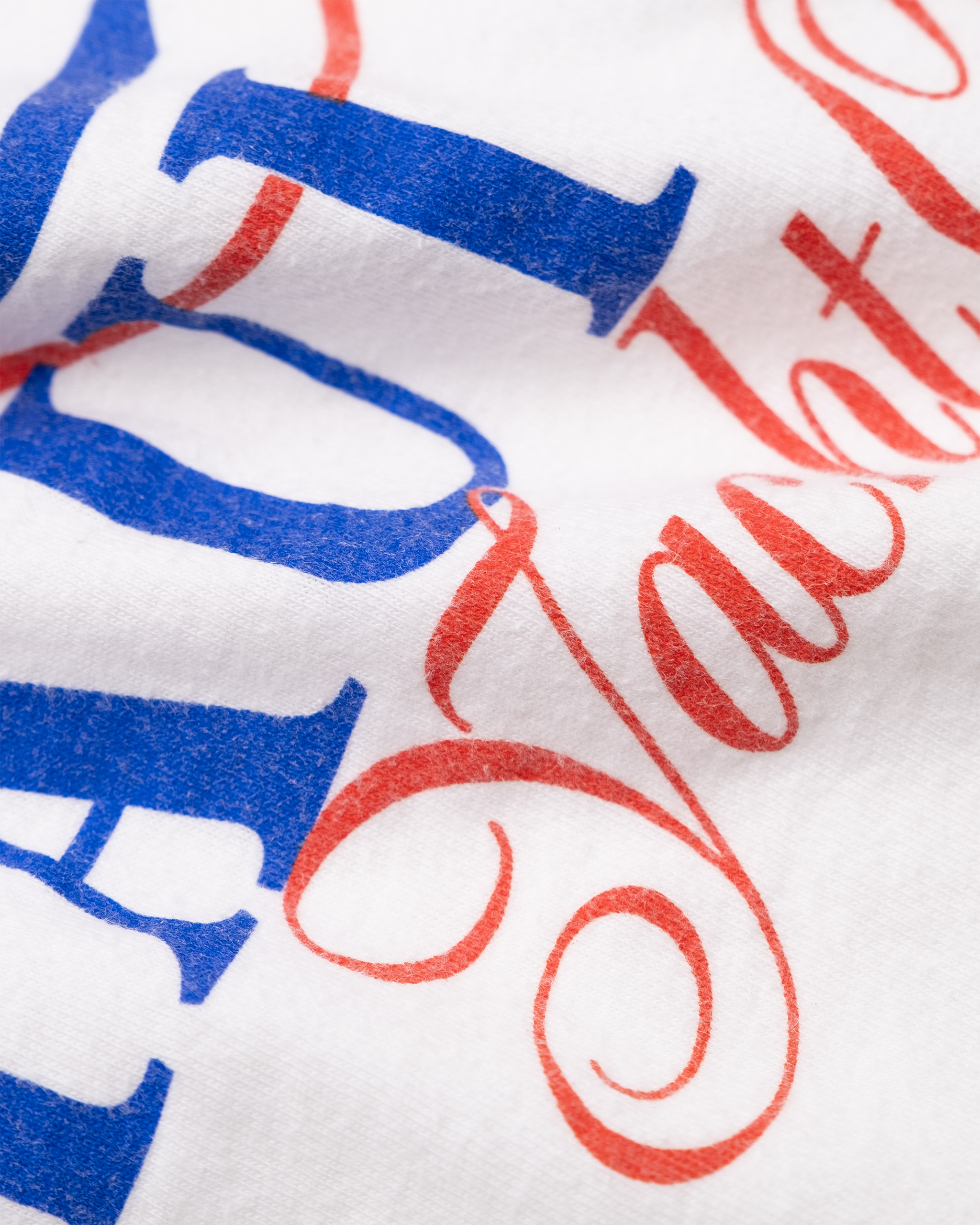 Close-up of aged red and blue screen print on 1987 Maui Bay Yacht Club T-shirt.