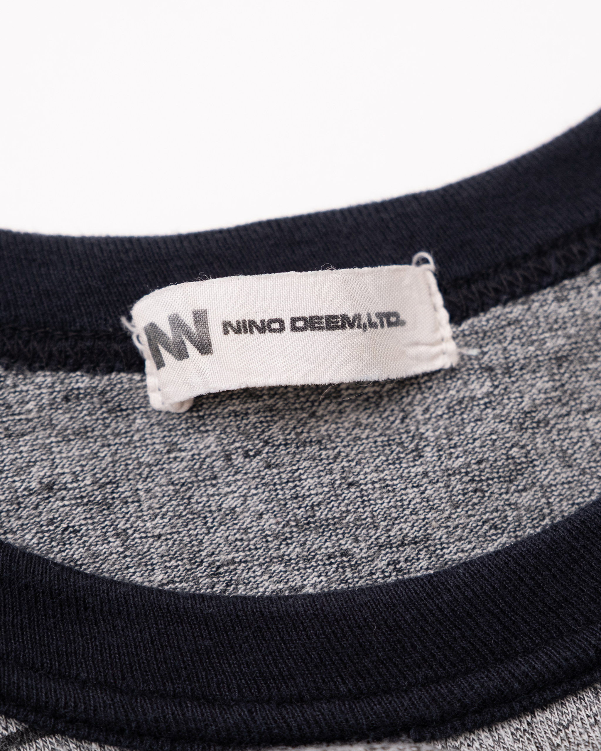 Nino Deem, Ltd. neck label on 1990s contrast sleeveless top.