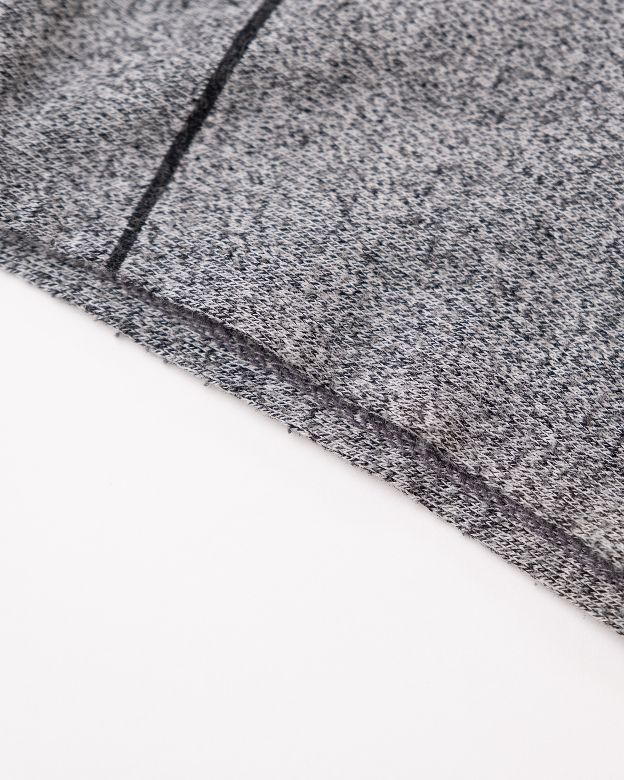 Close-up of black contrast arm opening and heather gray knit fabric on 1990s Nino Deem sleeveless top.